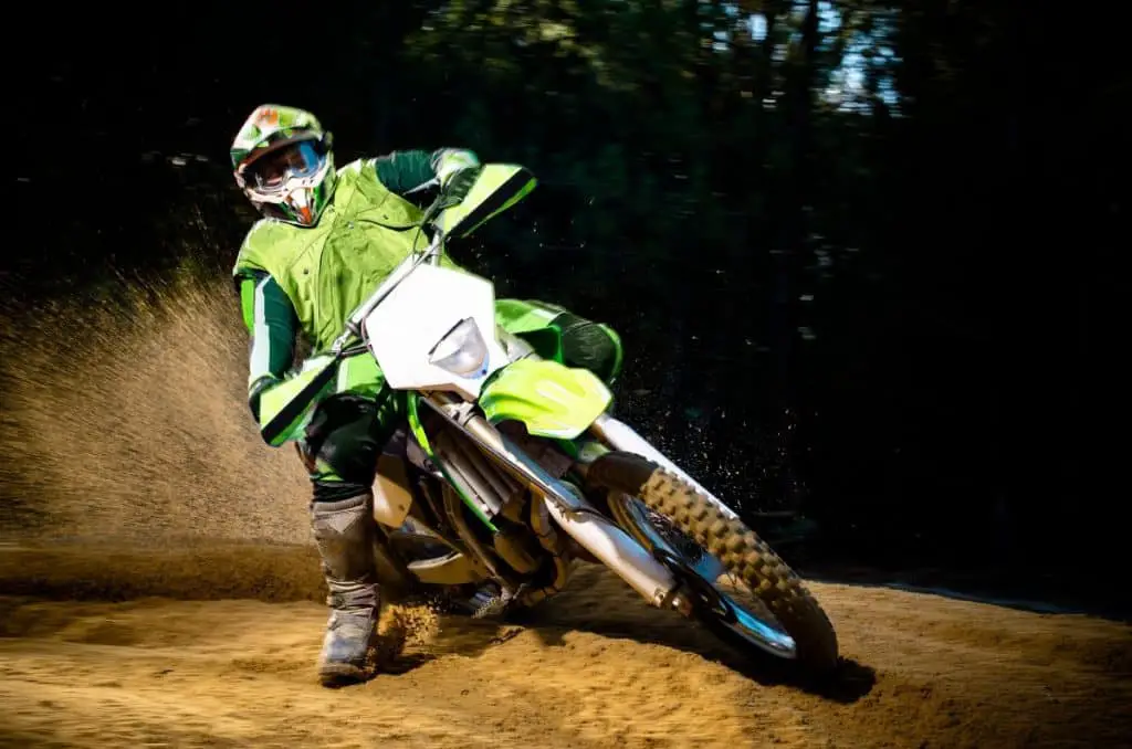 Enduro bike rider on action. Turn on sand terrain