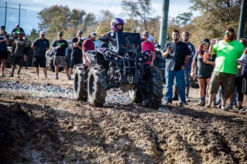 kid on atv on mud track