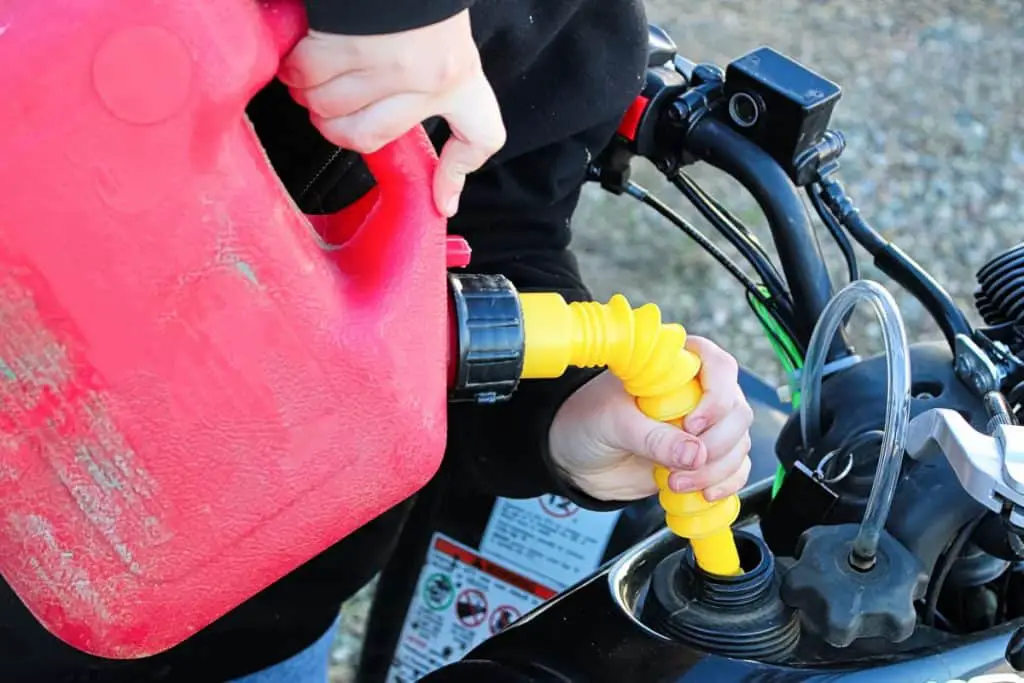 Filling a gas tank up on a quad