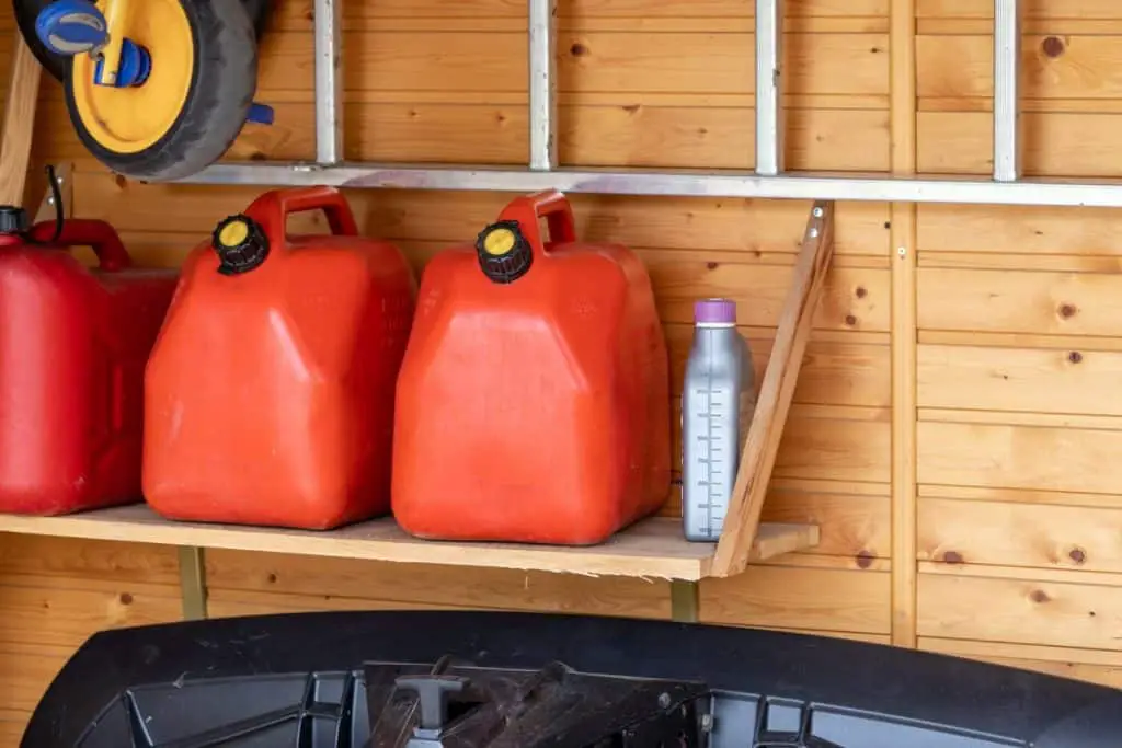 Garage corner with three red plastic fuel cans