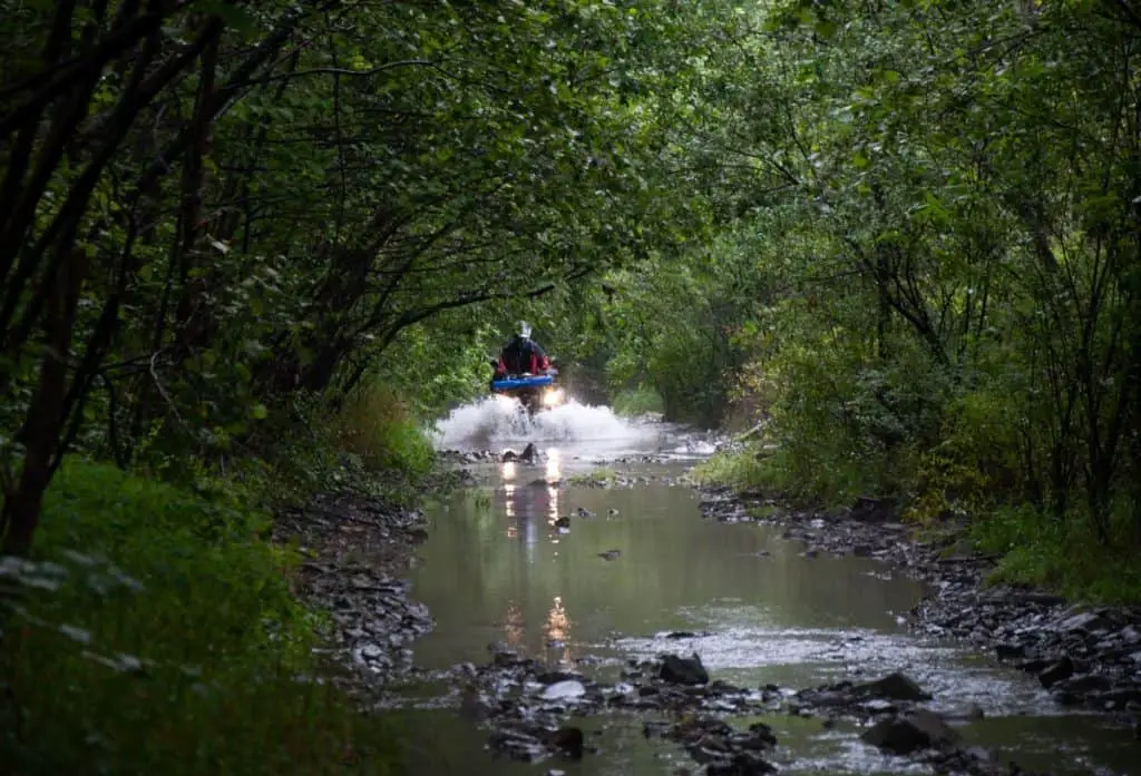 ATV in the expedition overcomes the water barrier