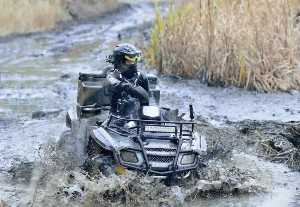 Cool pictures of active ATV driving in mud and water at Autumn weather