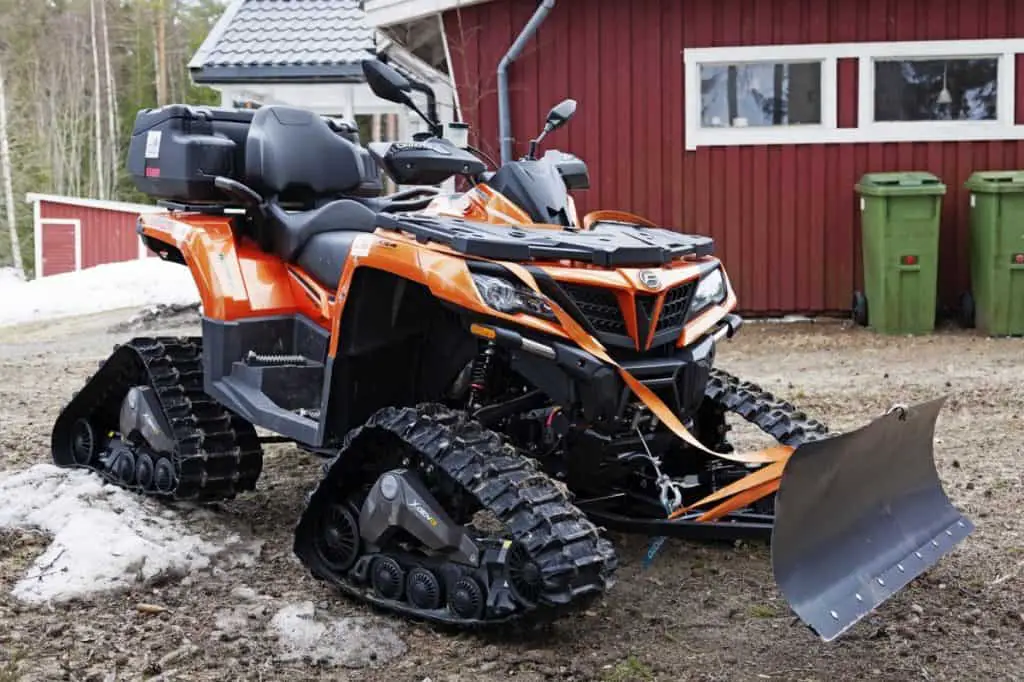Vehicles with snow chains reminiscent of a quad bike