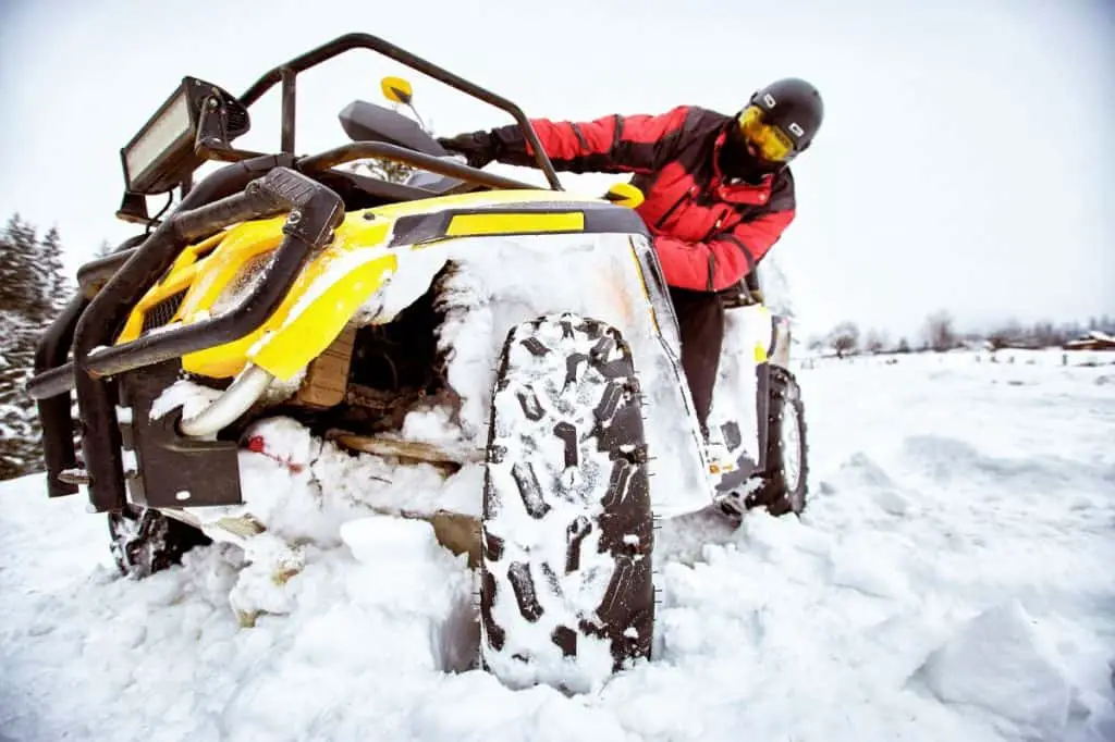 Winter race on an ATV on snow in the forest